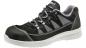 Preview: The shoe is a lightweight, black athletic shoe with gray and white accents. It has a grippy sole and laces that provide a snug fit. The upper is comfortably padded.