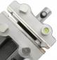 Preview: The image shows a metallic device with smooth, edged surfaces. There are screws, a level indicator, and a small cylinder. The surface is partly matte, partly glossy.