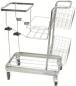 Preview: The image shows a silver serving cart with four wheels. It has multiple shelves in the form of a wire basket and a flat surface on top. The frame is made of metal.