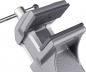 Preview: The image shows a gray metal vise. It has two wide, flat jaws that serve to hold objects. A screw on the side allows the opening and closing of the jaws.