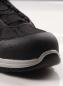Preview: The image shows the front part of a black shoe with a sturdy rubber sole and a reinforced toe. The shoe has a textile upper and laces.