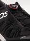 Preview: The image shows a black sports shoe with a tight, breathable material and lacing adjusted by a red-black push button. A logo is visible.