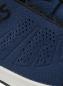 Preview: The image shows a blue sports shoe with a textured upper. There are breathable, perforated areas and a white sole. The brand name is visible, in black.