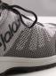 Preview: The image shows a gray sports or running shoe. It features a breathable, knitted upper with a subtle pattern and gray laces. The shoe has a light-colored sole.