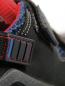 Preview: The image shows a close-up of a shoe. The shoe is black with blue and red accents. A buckle and stitching are visible, the fabric appears sturdy and sporty.