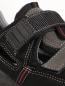 Preview: The image shows a black shoe with gray and red accents. It has an adjustable mesh strap and a textured sole. The shoe appears sturdy and sporty.