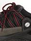Preview: The image shows a black shoe with red and gray accents. The surface is made of fabric with a mesh design, and the laces are loosely tied. The shoe has a sturdy sole.