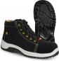 Preview: The image shows a pair of black safety shoes with yellow accents. The shoes have a high-top design, laces, and a non-slip, textured sole. The heel is stable.