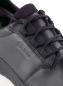 Preview: The image shows a black leather shoe with laces. The surface appears smooth and modern, and the logo is visible on the side.