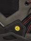 Preview: The image shows part of a shoe, primarily in gray and black. There are red striped details and a yellow ESD marking. The materials appear sturdy and durable.