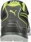 Preview: The image shows the back of a black sports shoe with a green accent. The Puma logo is displayed on the heel. The sole structure is sturdy and provides good grip.