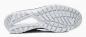 Preview: The image shows the sole of a sports shoe. It is made of rubber, has a wavy pattern with multiple grooves and indentations for better grip. The color is predominantly light.