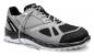 Preview: The shoe is a light, gray sneaker with a black part at the front. It features a breathable upper, a flexible sole, and a sporty look.