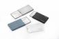 Preview: In the picture, there are four slim card cases in different colors (gray, blue, black, and white). Two of the cases are open and display integrated mirrors.