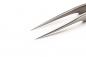Preview: The image shows the tip of a long, slender pair of metal pliers with two sharp, pointed ends. The background is plain and white, which makes the pliers stand out prominently.