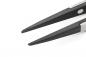 Preview: The image shows the tips of a pair of scissors. The blades are narrow and pointed, with a shiny silver surface and a matte, black coating on the edges.