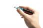 Preview: A hand is holding a pair of tweezers. The tweezers have a black handle with blue accents and a curved metal tip. The background is white and neutral.