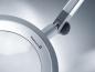 Preview: The image displays a modern magnifying glass with a large, round lens, surrounded by a slim silver frame. An adjustable arm allows for flexible positioning.
