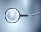Preview: The image shows a large magnifying glass with a round, illuminated frame. It has a long, flexible neck and is positioned in soft light. The background is bright and monochromatic.
