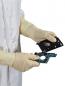 Preview: A person in white gloves is holding two parts of a computer drive. The upper part is black and has a round opening, the lower part is green with fine circuits.