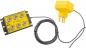 Preview: The image shows a yellow electric plug connected to a black connection panel with six sockets. The connection panel is labeled with safety-related notices.