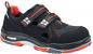 Preview: The shoe is black with red accents. It has two Velcro straps, a sporty shape, and a padded sole. The material appears sturdy and is suitable for work use.