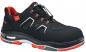 Preview: The shoe is a black safety shoe with red accents. It has a padded sole, a reinforced toe cap, and elastic laces for a comfortable fit.