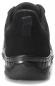 Preview: The image shows the rear view of a black sports shoe. The sole is shiny and slightly elevated, while the upper part is made of a matte fabric. A small section for the laces is visible.