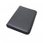 Preview: The image displays a black, flat folder made of faux leather. It has a smooth surface and a yellow tag in the bottom right corner. The folder is closed and rectangular.