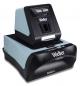 Preview: The image shows a device in black and light blue that looks like a small machine. On top, there is a vertical unit with buttons, and below, an area for inserting materials.