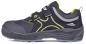 Preview: The shoe is sporty, black with yellow and gray accents. It has a wide, stable heel and a Velcro closure. The surface is made of a sturdy material.