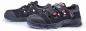 Preview: These are black safety shoes with a sturdy rubber sole and multiple Velcro fastenings. They feature closed toes and side ventilation openings for comfort.