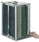 Preview: The image shows a rectangular metal device bay with several vertically arranged green circuit boards. A hand reaches for the left side of the device.