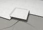 Preview: The image shows a floor covering made of light, marbled tiles. One tile is slightly shifted and placed over a crack in the substrate. The substrate is gray.