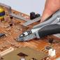 Preview: In the picture, you can see a hand holding a pair of pliers. It is being used to work on an electronic circuit board that has many small components and traces on a brown surface.
