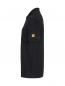 Preview: The image shows a black polo shirt from a side view. It has short sleeves and a small yellow logo on the left sleeve. The fabric appears smooth and formal.
