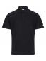 Preview: The image shows a black polo shirt. It features a short collar, a button closure, and a small chest pocket on the left side. A yellow logo is visible on one sleeve.