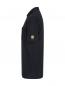 Preview: The image shows a black polo shirt in a side view. It has a collar and short sleeves. There is a yellow logo on one sleeve. The cut is straight and simple.