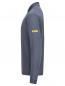 Preview: The image shows a long-sleeved, gray top. It has a stand-up collar and a simple, modern cut. There is a yellow logo on one sleeve.