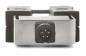 Preview: The image shows a metallic plug with a round socket that has five metallic contacts. The plug is framed in a gray holder with black edges.