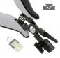 Preview: The image shows a black and gray pliers with a spring mechanism. Next to the pliers is a small, black clip. In the upper right, there's a simple symbol with a downward arrow.