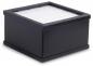 Preview: The image shows a rectangular black box with a grid-like white lid. The box has smooth sides and appears sturdy.