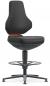 Preview: The chair has a high, ergonomic backrest and a wide seat. It stands on a stable, round base with five legs and a footrest. The surface is black with an orange accent.