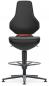 Preview: The chair has a tall, narrow backrest and a padded seat. It stands on a stable base with five casters and a round footrest. The color scheme is predominantly black.