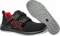 Preview: The image shows a pair of black shoes with red accents. They have a sporty shape and Velcro fasteners. The sole is grippy and features a textured pattern.