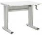 Preview: The table has a rectangular, white surface and is mounted on two silver legs with a sturdy frame. On one side, there is a hand crank for height adjustment.