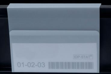 The image shows a white envelope with a transparent flap. On it are numbers ("01-02-03") and a barcode printed. The background is dark.