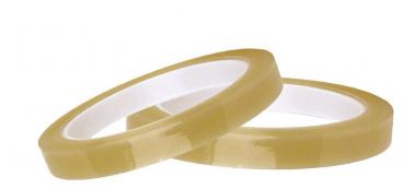 In the image, there are two rolls of transparent adhesive labels in a light, beige tone. The rolls are placed next to each other, with a round, white inner area.