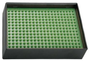 The image shows a rectangular black container with a surface made of green, perforated material. The holes are evenly spaced and small. It appears solid and stable.