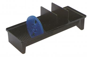 The image shows an elongated, black plastic tray with three vertical dividers. In the center is a blue, round lid. The tray has a textured surface.